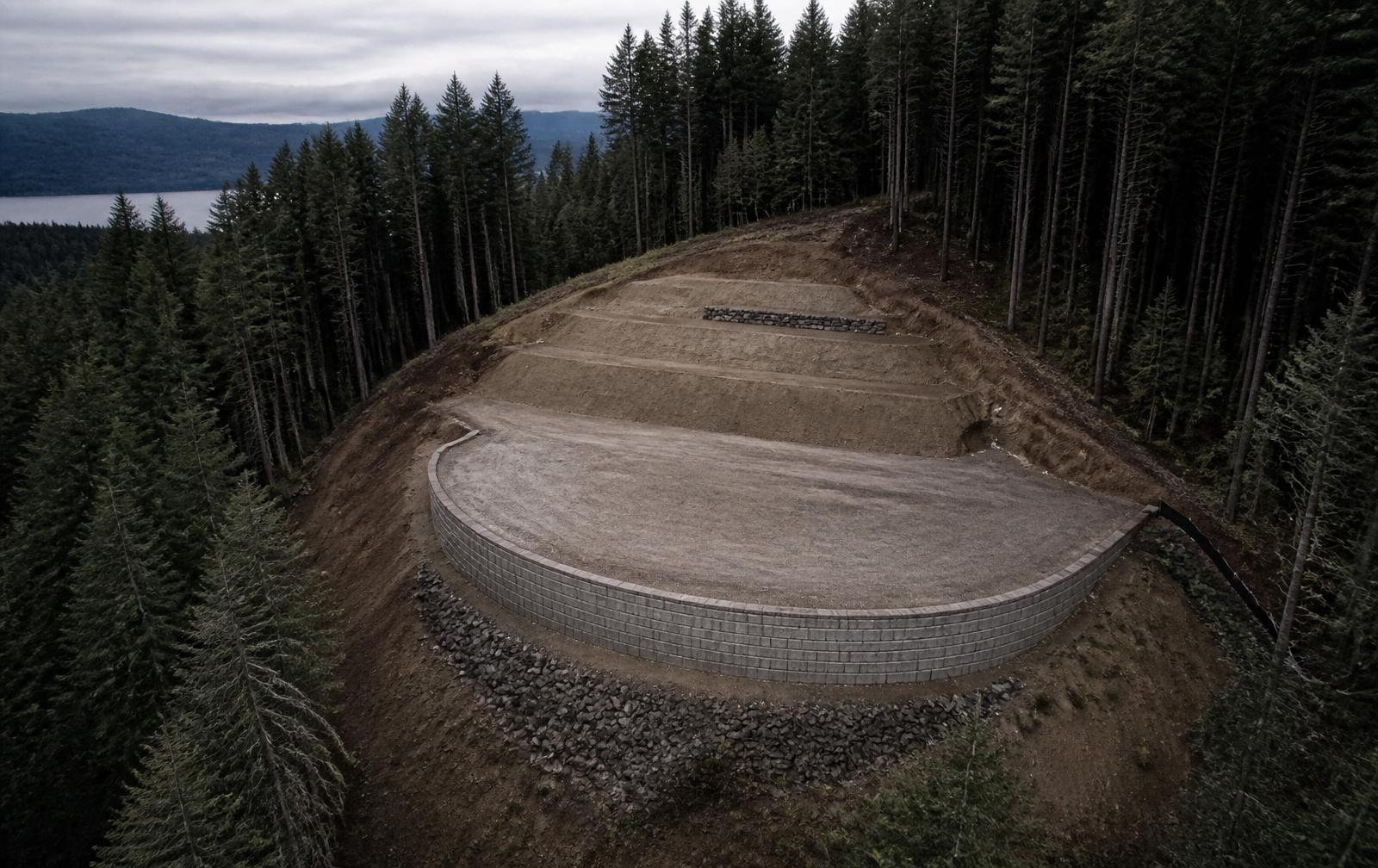 Aerial view of completed hillside terracing and engineered block retaining wall at The Ridge Residence, West Hills, Oregon